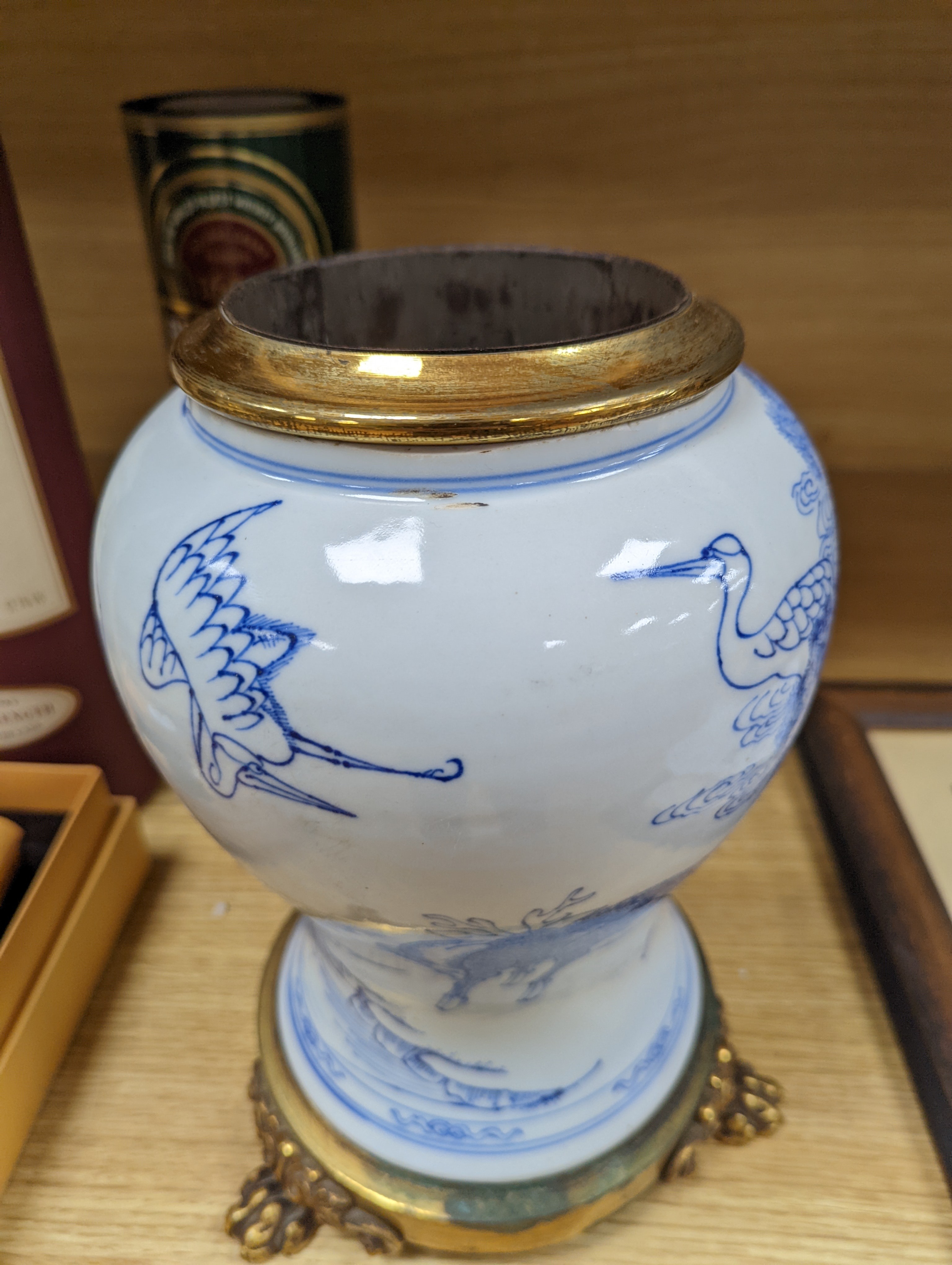 A Chinese blue and white baluster vase, brass mounted 29cm